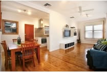 Bright living and dining area with timber floors