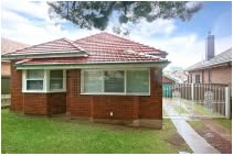 Single-storey brick home with a red tiled roof